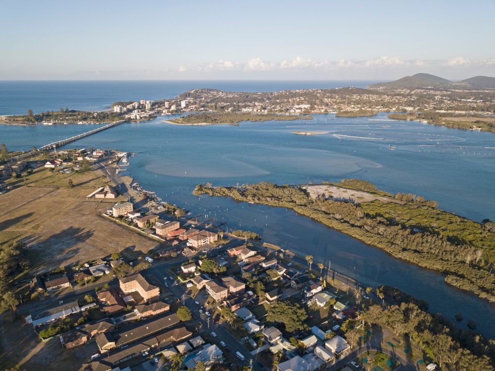 An Aerial View of a Town in Forster Next to a Large Body of Water — Currie Bros Engine Reconditioners in Forster, NSW