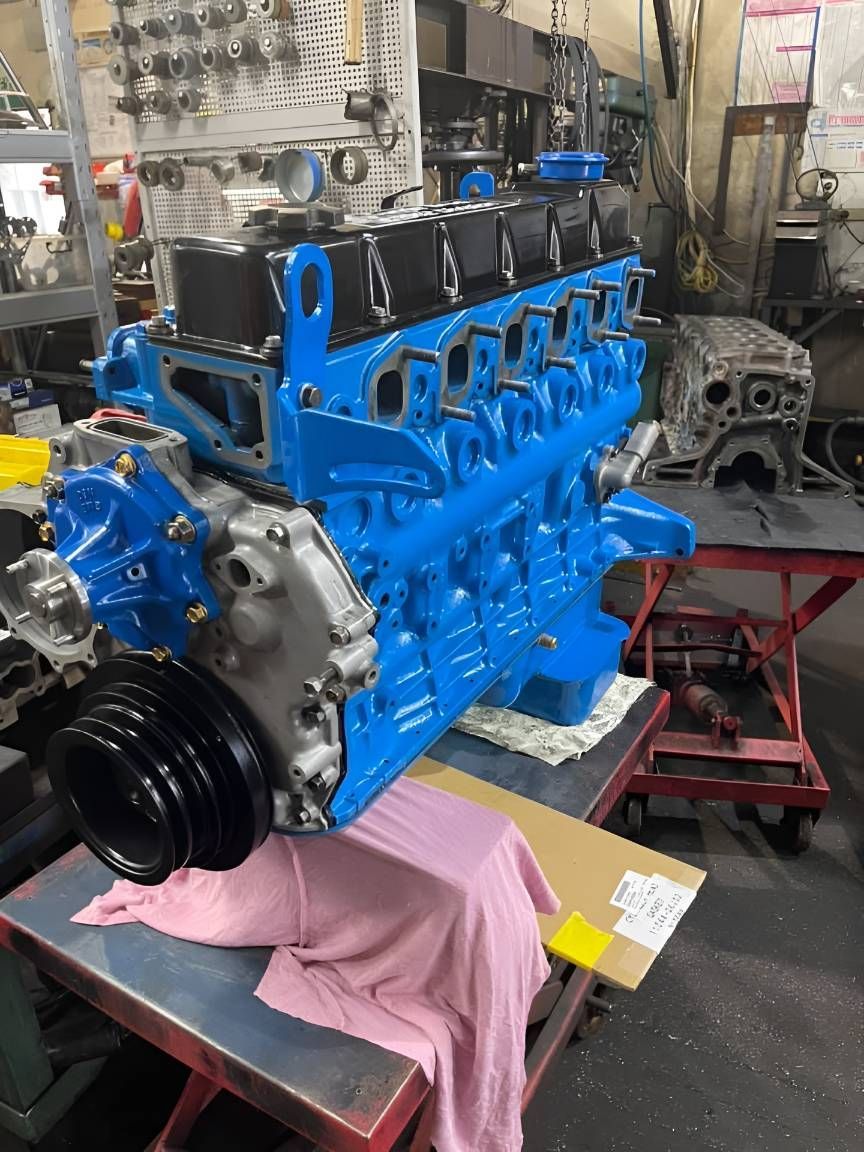 A Blue Engine is Sitting on a Table in a Garage — Currie Bros Engine Reconditioners in Laurieton, NSW