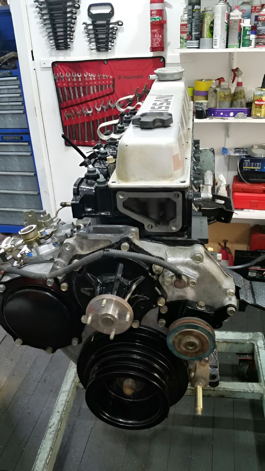 A Car Engine is Sitting on a Table in a Garage — Currie Bros Engine Reconditioners in Wauchope, NSW