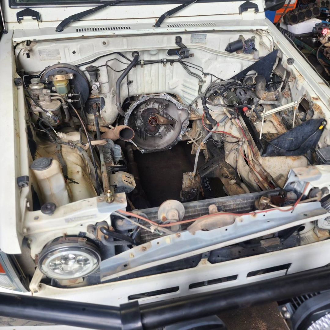 A White Car With the Hood Open and the Engine Exposed — Currie Bros Engine Reconditioners in Taree, NSW