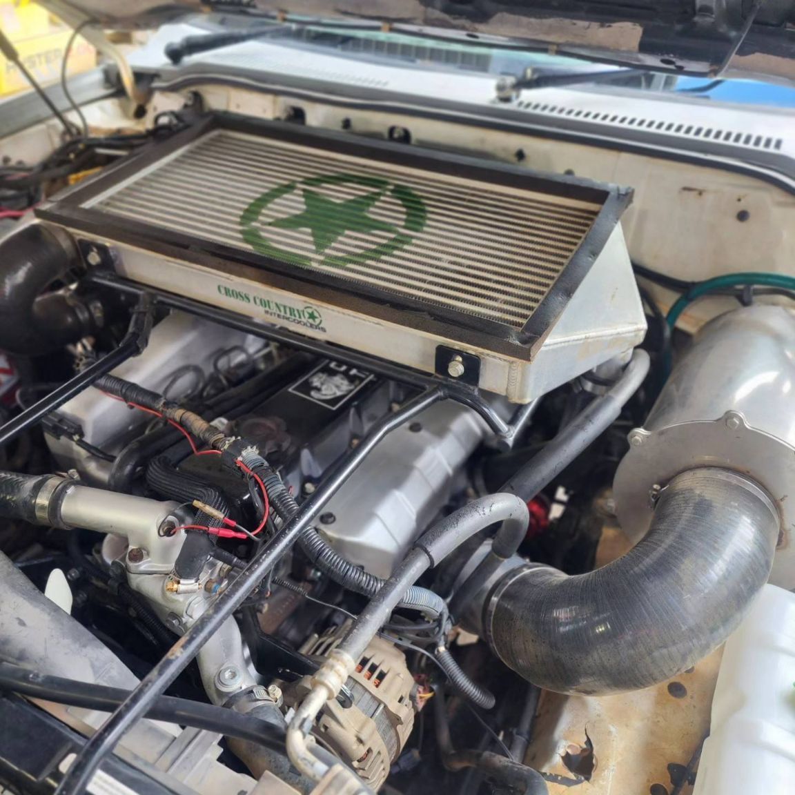 A Close Up of a Car Engine With a Green Star on It — Currie Bros Engine Reconditioners in Forster, NSW
