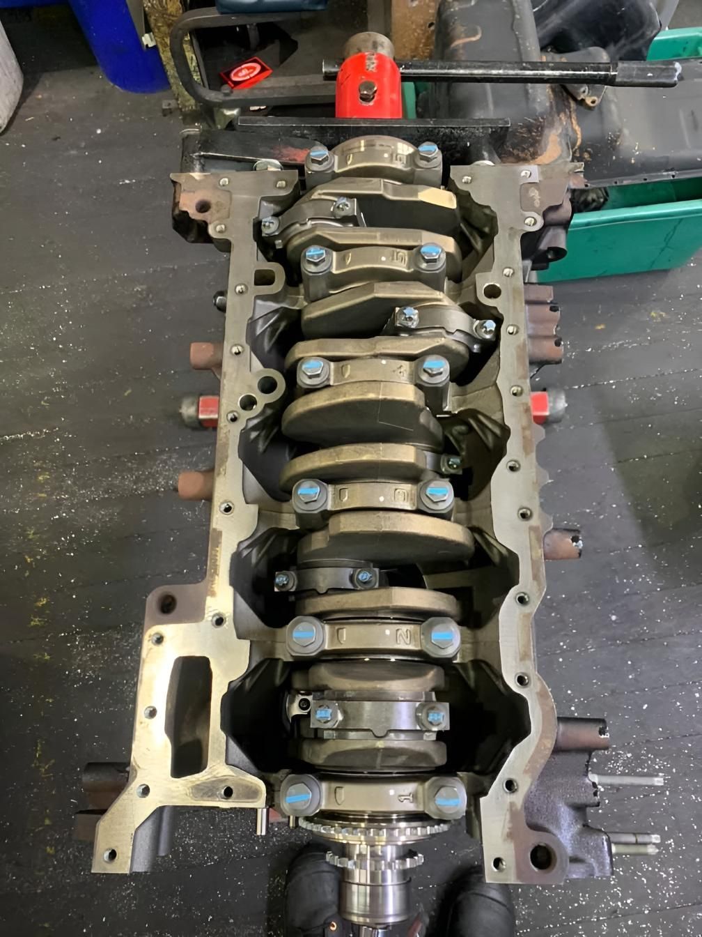 The Crankshaft of a Car Engine is Being Worked on in a Garage — Currie Bros Engine Reconditioners in Port Macquarie, NSW