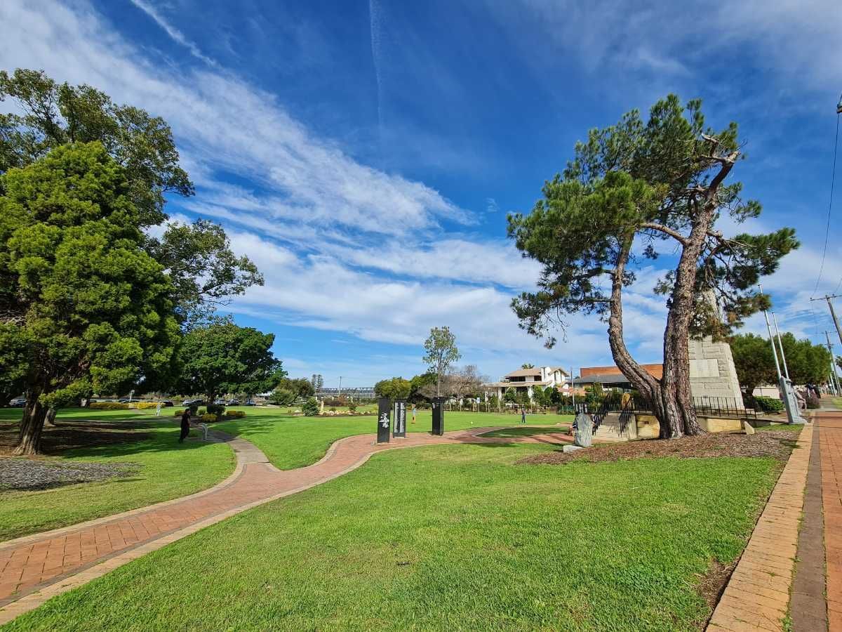 A Park in Taree With a Brick Walkway and Trees on a Sunny Day — Currie Bros Engine Reconditioners in Taree, NSW