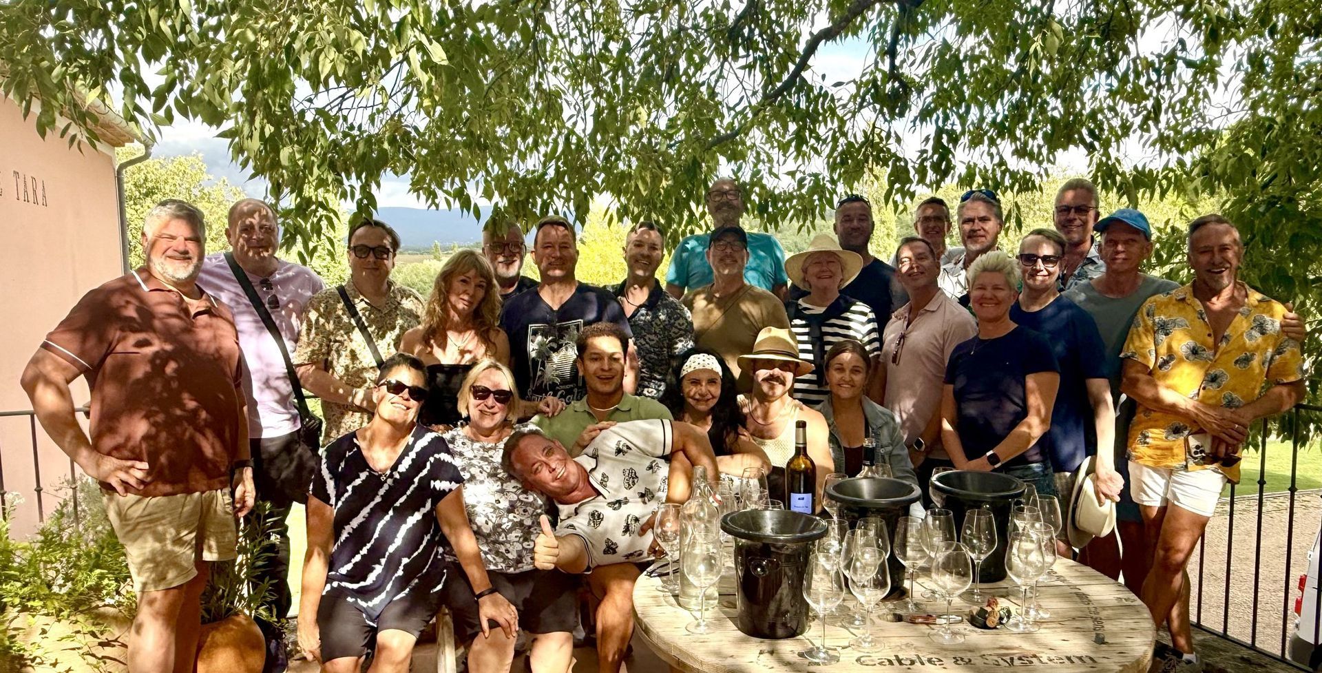 Hermes Holidays group in the dappled shade at Domaine de Tara, gay tour of Provence
