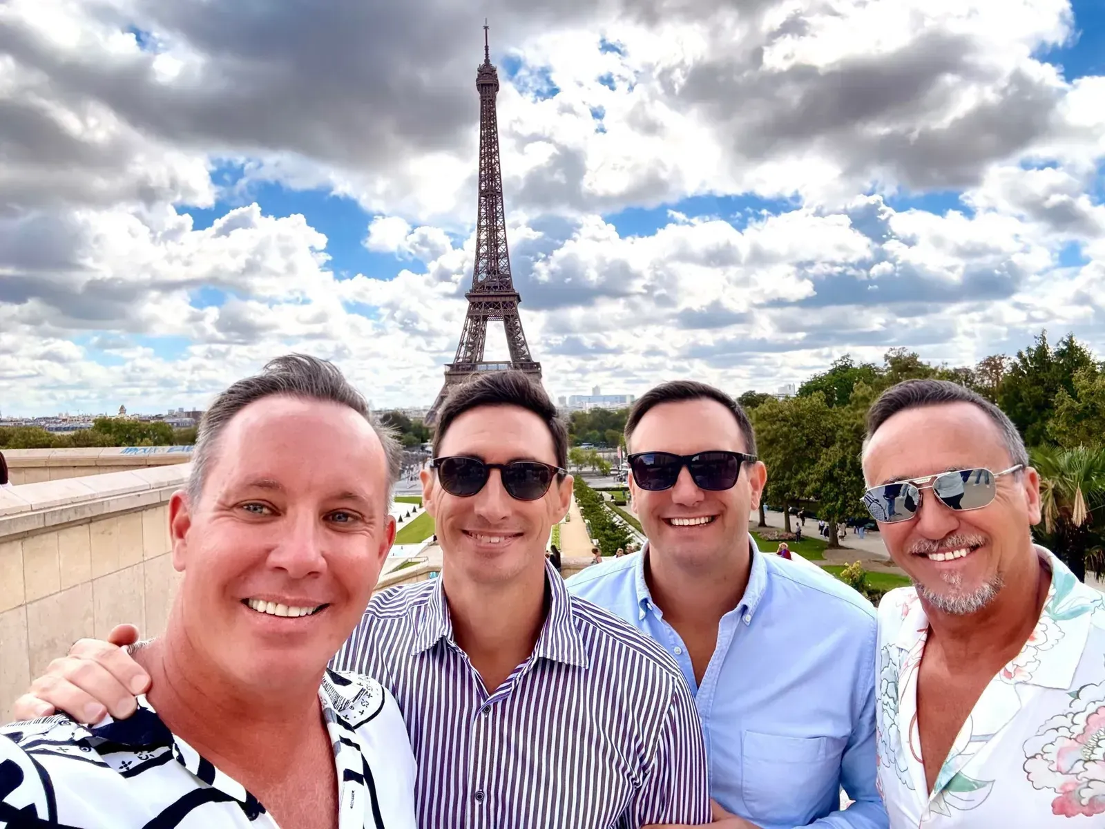 Kyle and Wayne with friends in front of the Eiffel Tower