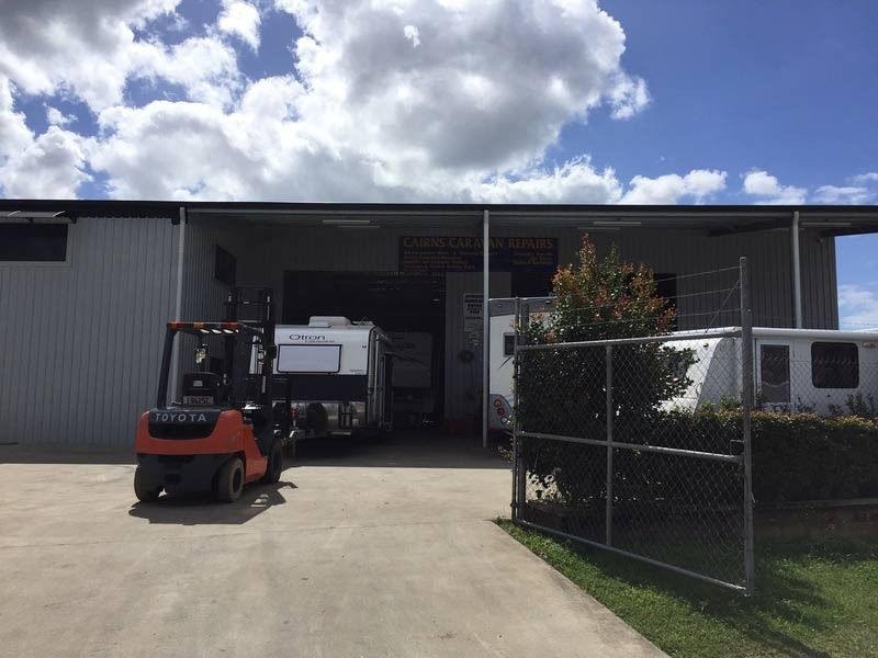 A Forklift Is Parked In Front Of A Building — Cairns Caravan Repairs In Edmonton, QLD