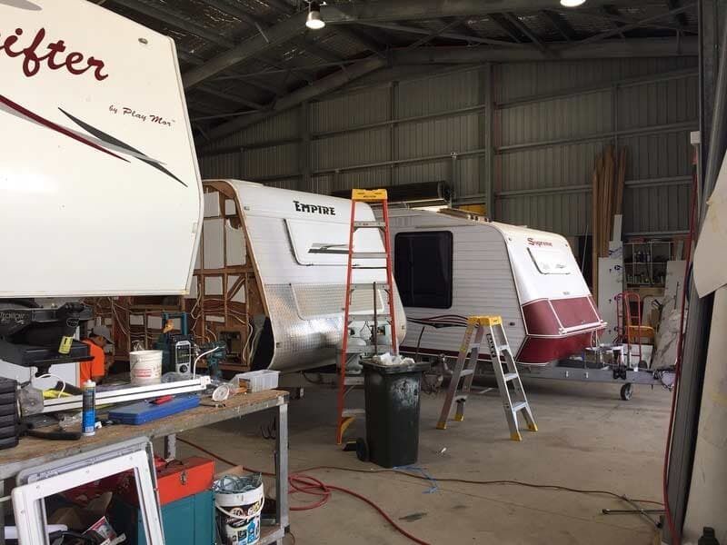 A Camper Is Being Built In A Garage With Other Camper Trailers — Cairns Caravan Repairs In Edmonton, QLD