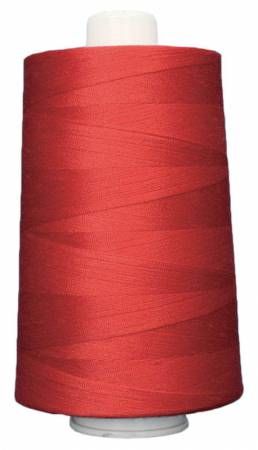 Red spool of thread on a white background