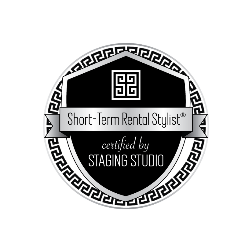 Black and white circular badge reading “Short-Term Rental Stylist,” certified by Staging Studio.