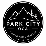 Black circular Park City Local logo with white mountain graphic and “Owned and Operated” text