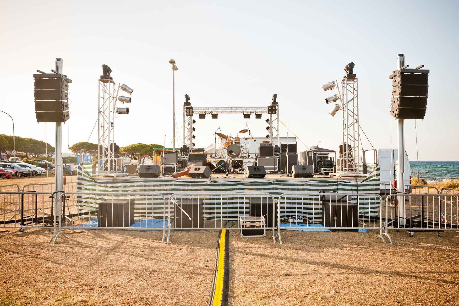 A large stage is set up on the beach for a concert.