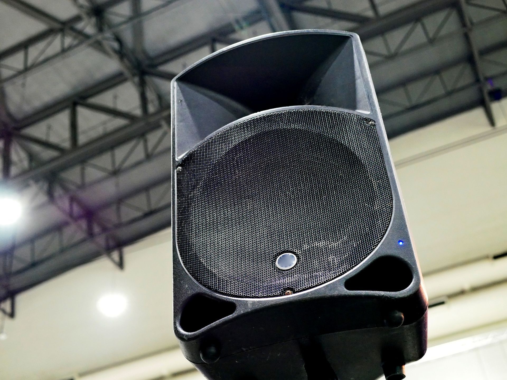 Black speaker mounted indoors.