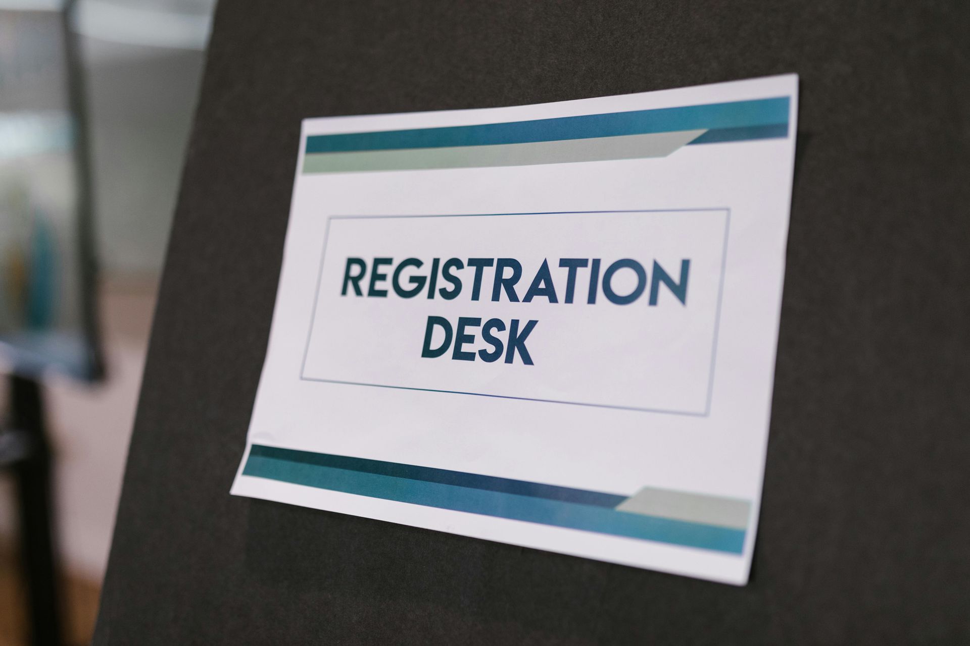 A sign that says registration desk on it