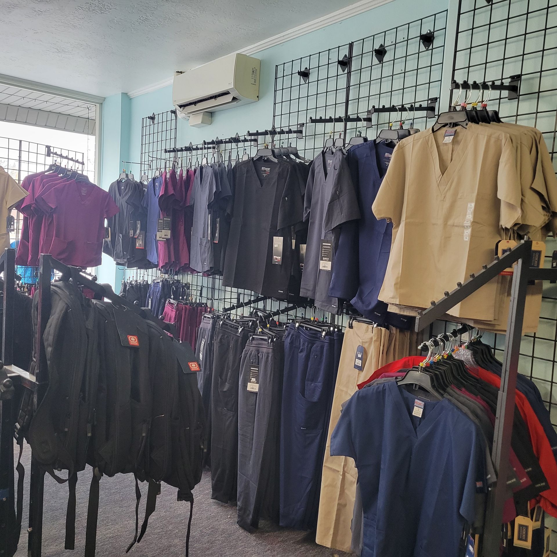 A bunch of shirts are hanging on a rack in a store