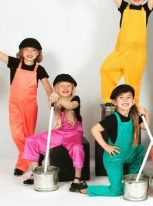 Four children in colorful overalls and hats pose with metal buckets and mops in a studio.