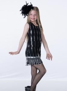 Girl posing in a black sequined dress and feather headpiece on a white background