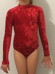 Person wearing a red velvet long-sleeve bodysuit against a plain background