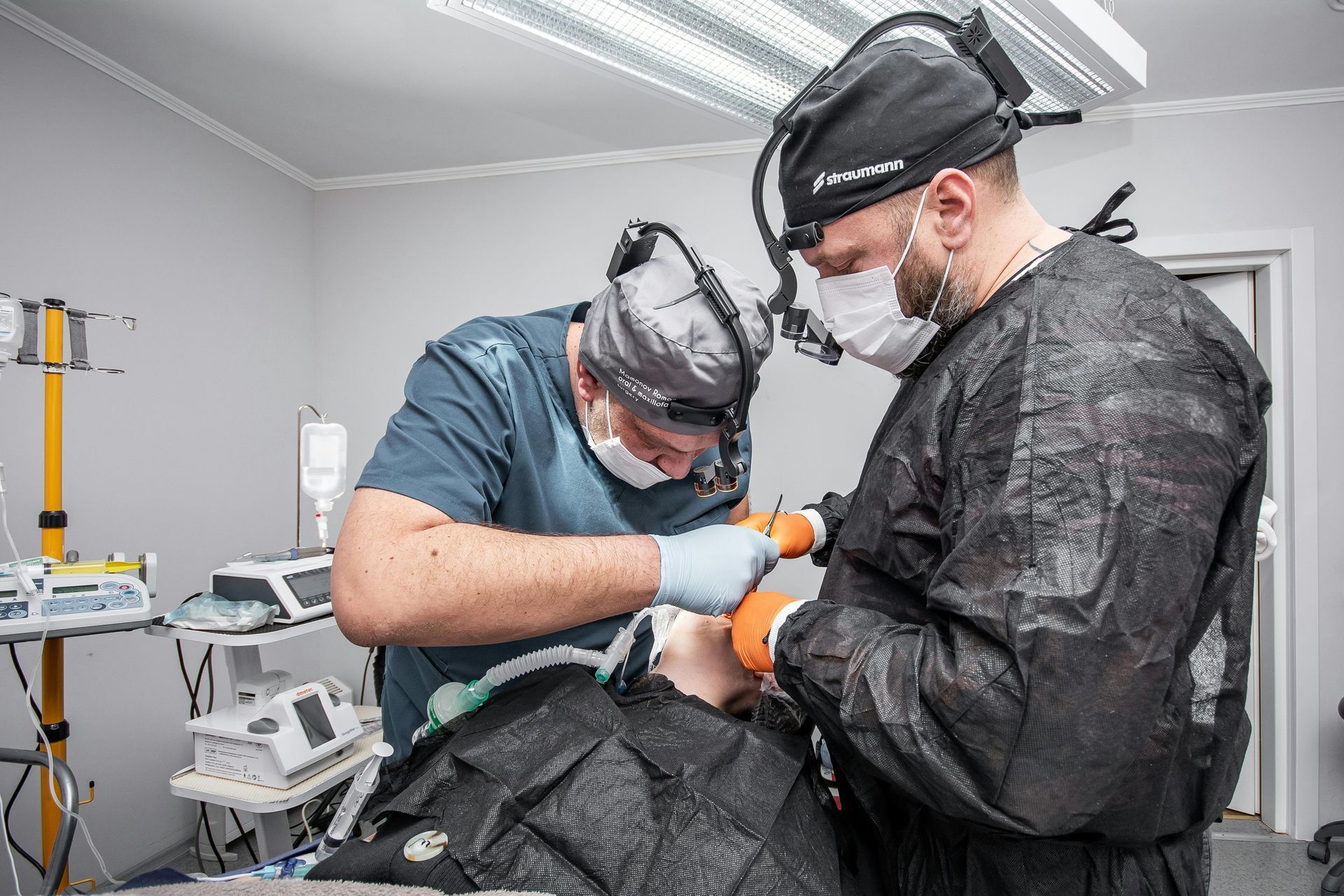 Two surgeons are working on a patient in an operating room.