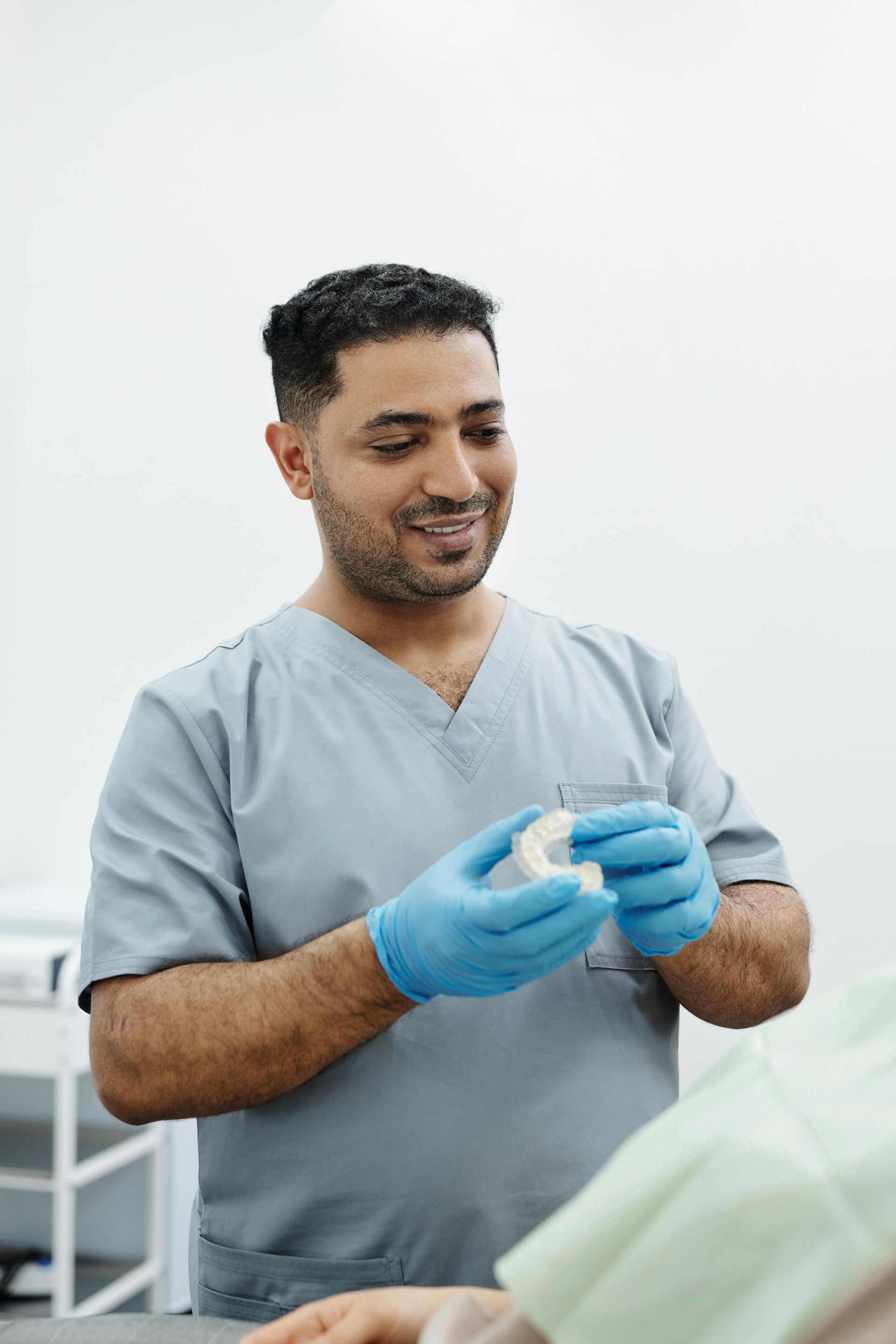 A dentist is holding a model of a person 's teeth.