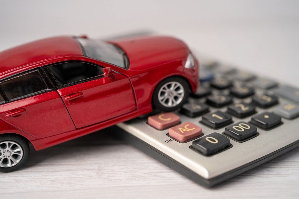 Red Toy Car on Placing on Calculator Keypad, Symbolising Car Finance — Old School Custom And Collision in Fawkner, VIC
