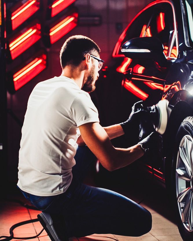 Mechanic Polishing a Black Car in A Garage — Old School Custom And Collision in Fawkner, VIC