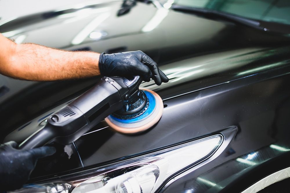 Person Buffing & Polishing a Black Car Bonnet — Old School Custom And Collision in Fawkner, VIC