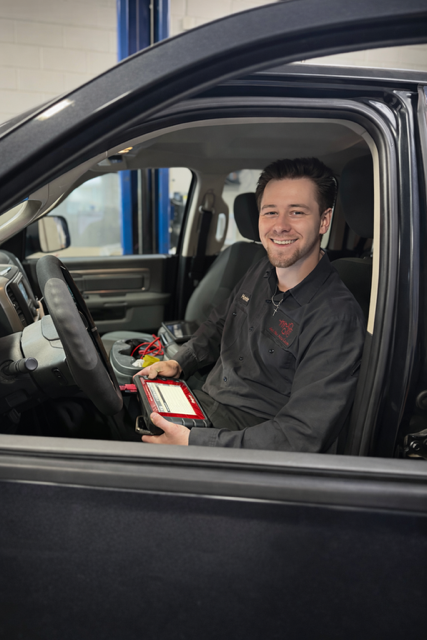 Technician in vehicle | Arie Nol Auto Center, Inc.