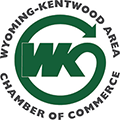 Green logo for Wyoming-Kentwood Area Chamber of Commerce: WK initials inside a circle with an arrow, text surrounding. | Arie Nol Auto Center
