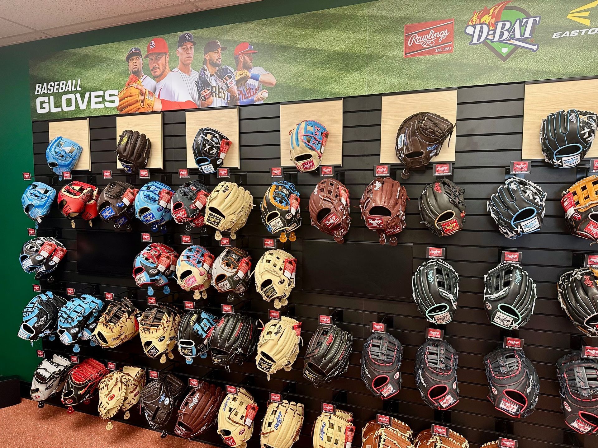 Display of colorful baseball gloves on a retail wall