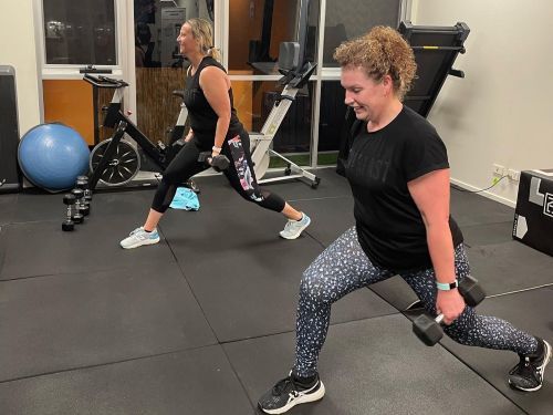 Two personal training clients performing lunges in the Key to Life Studio