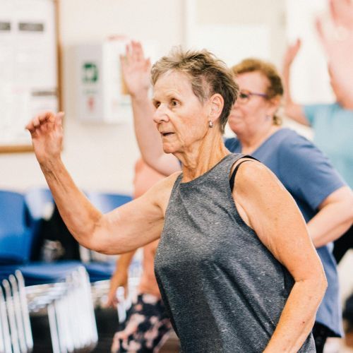 Woman completing a seniors fitness class