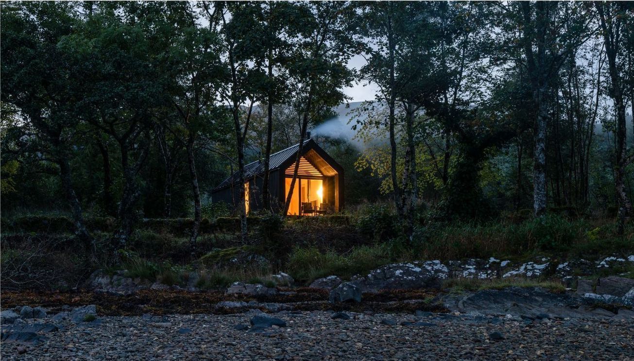 Kabn cabins surrounded by trees  in the Evening.