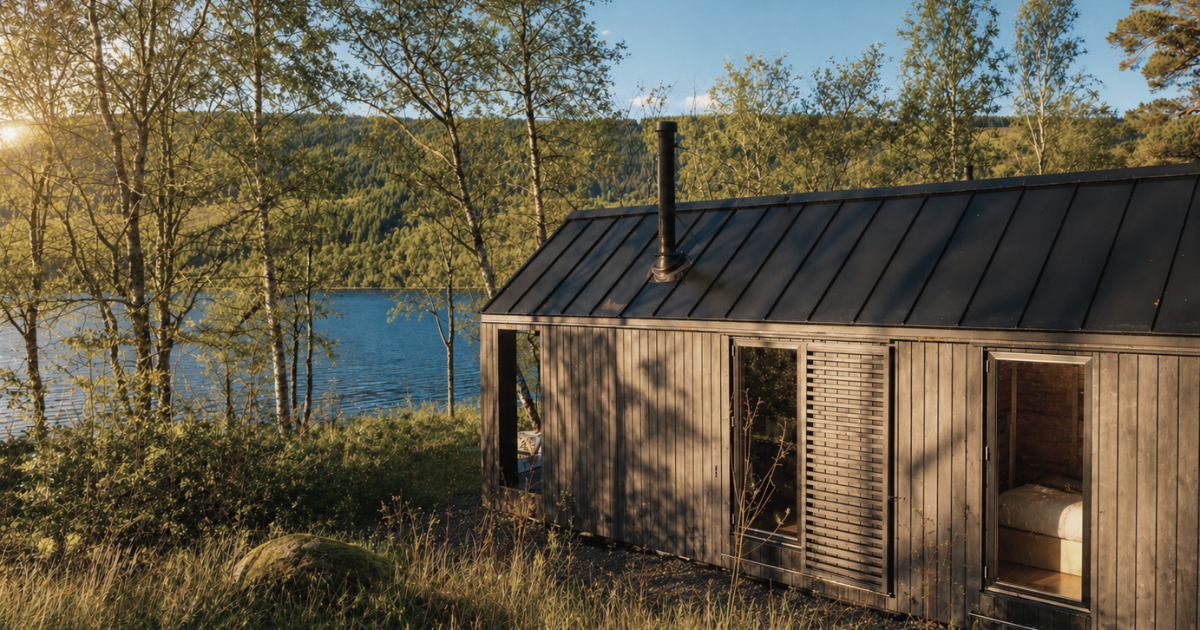 Exterior of a black luxury self catered cabin in nature.