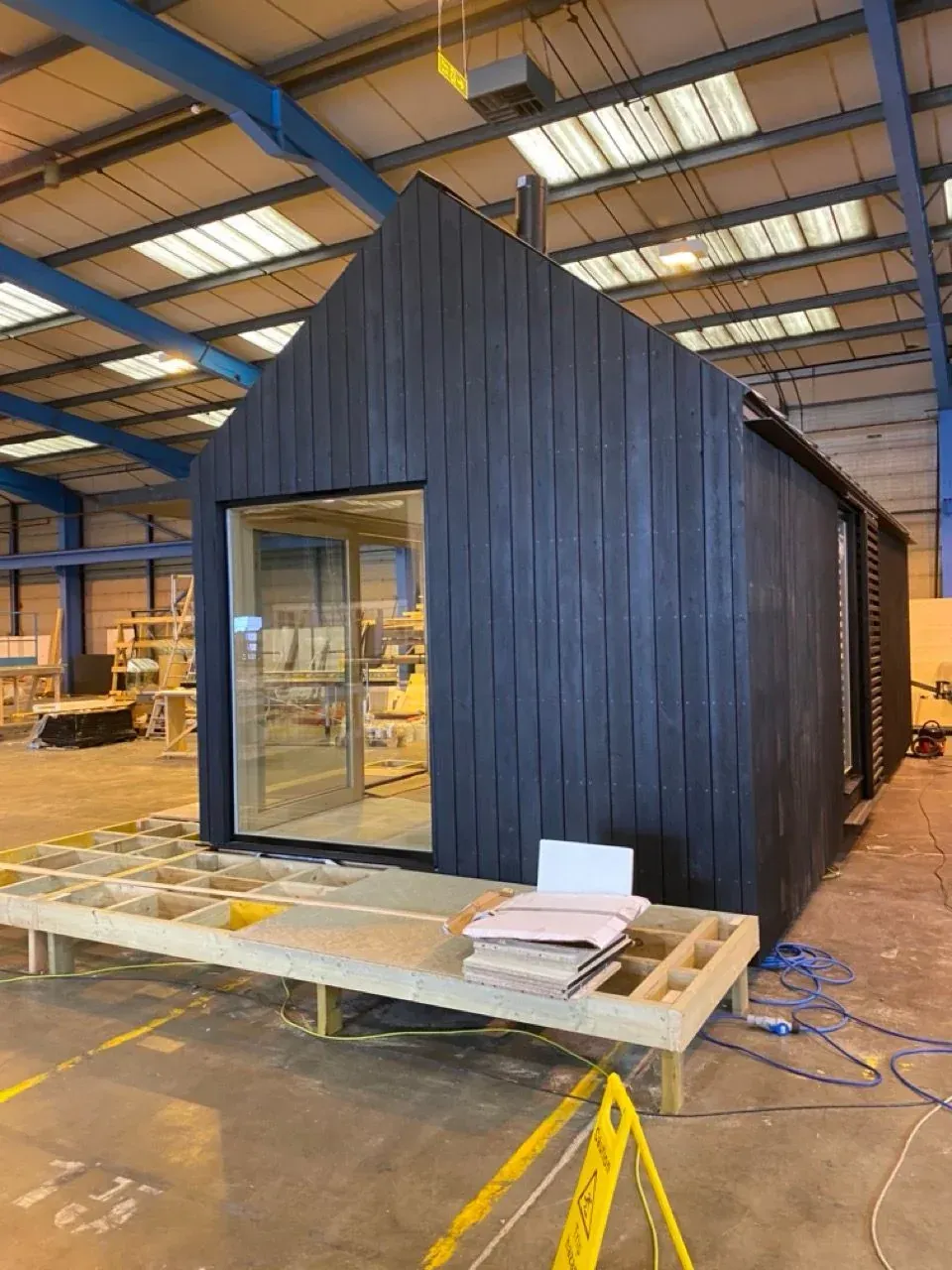 A Kabn cabin being built in a factory, showing sustainable prefabricated construction