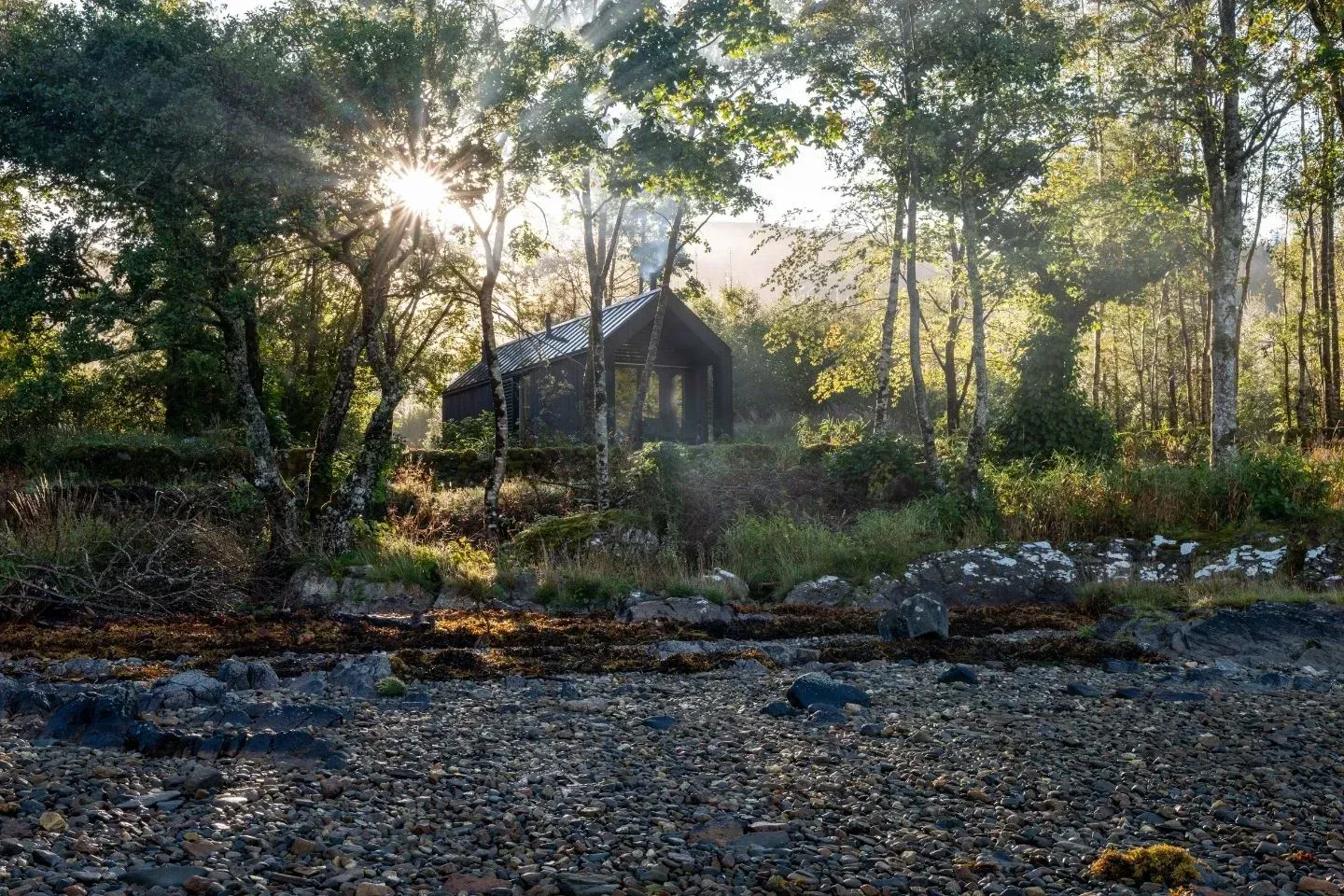 Sustainable luxury cabin exterior at sunset.