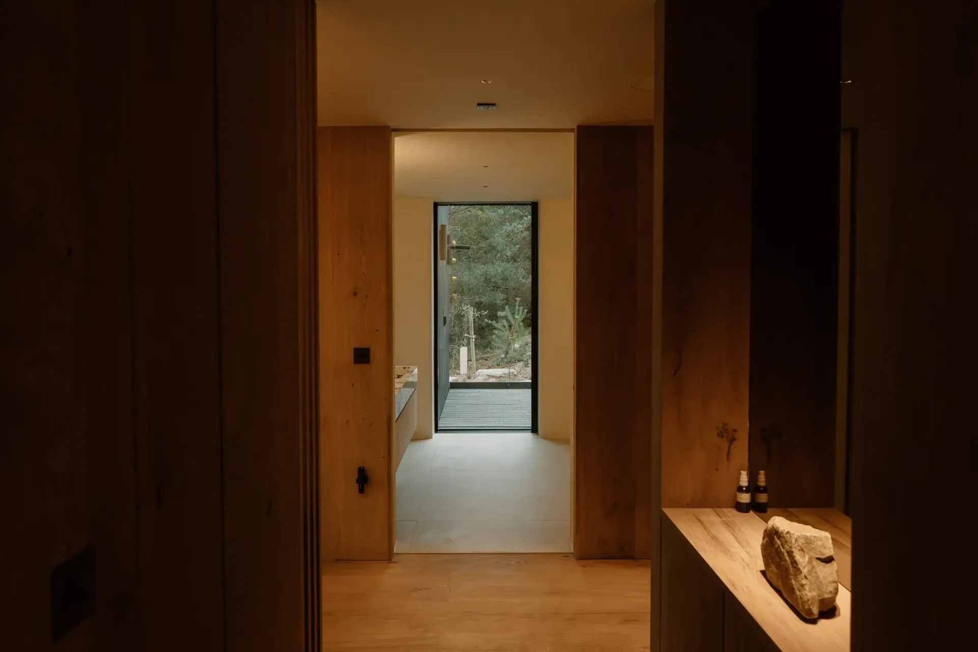Oak-lined hallway at Moya Kabn in the Cairngorms, with views towards the surrounding woodland