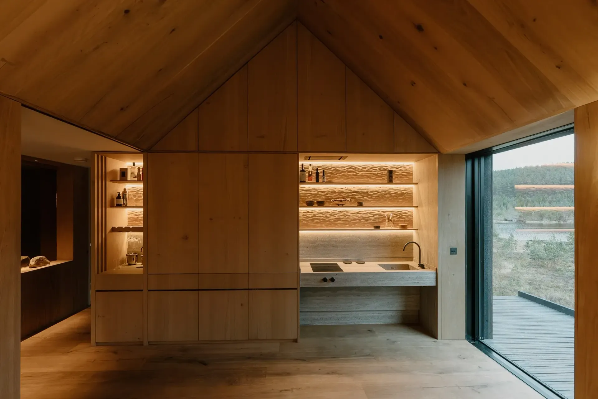 Handcrafted oak kitchen at Moya Kabn with integrated lighting and woodland views