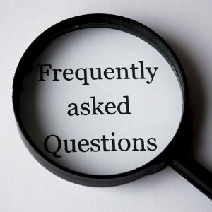 Magnifying glass over the words “Frequently asked Questions” on a white background