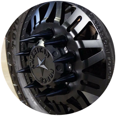 Black custom wheel rim with star center cap and silver spokes in close-up view