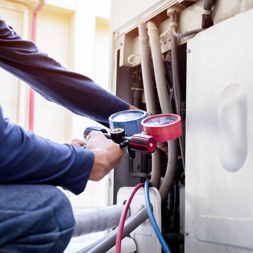 African-American technician working on an AC Unit.