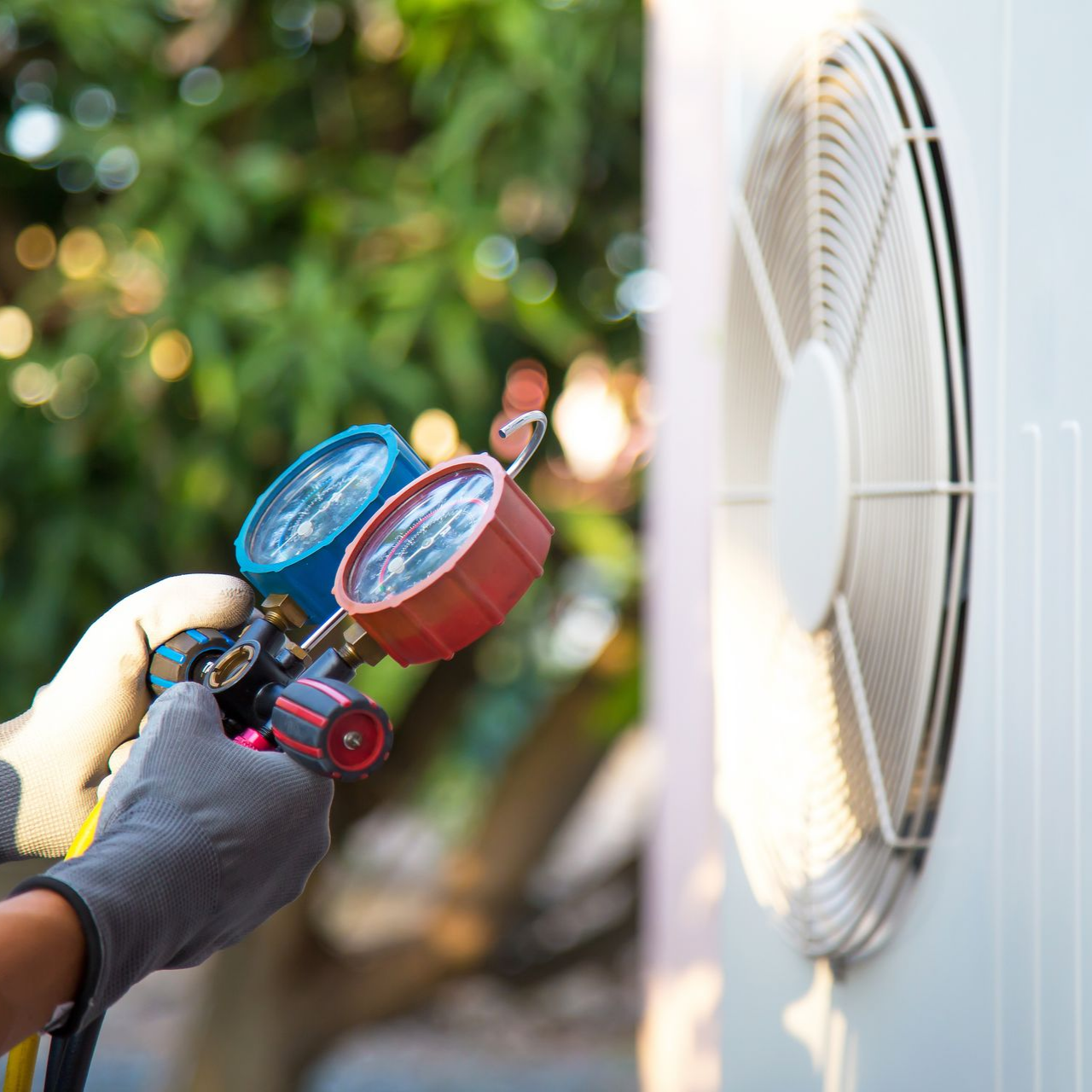 African-American technician working on an AC Unit.