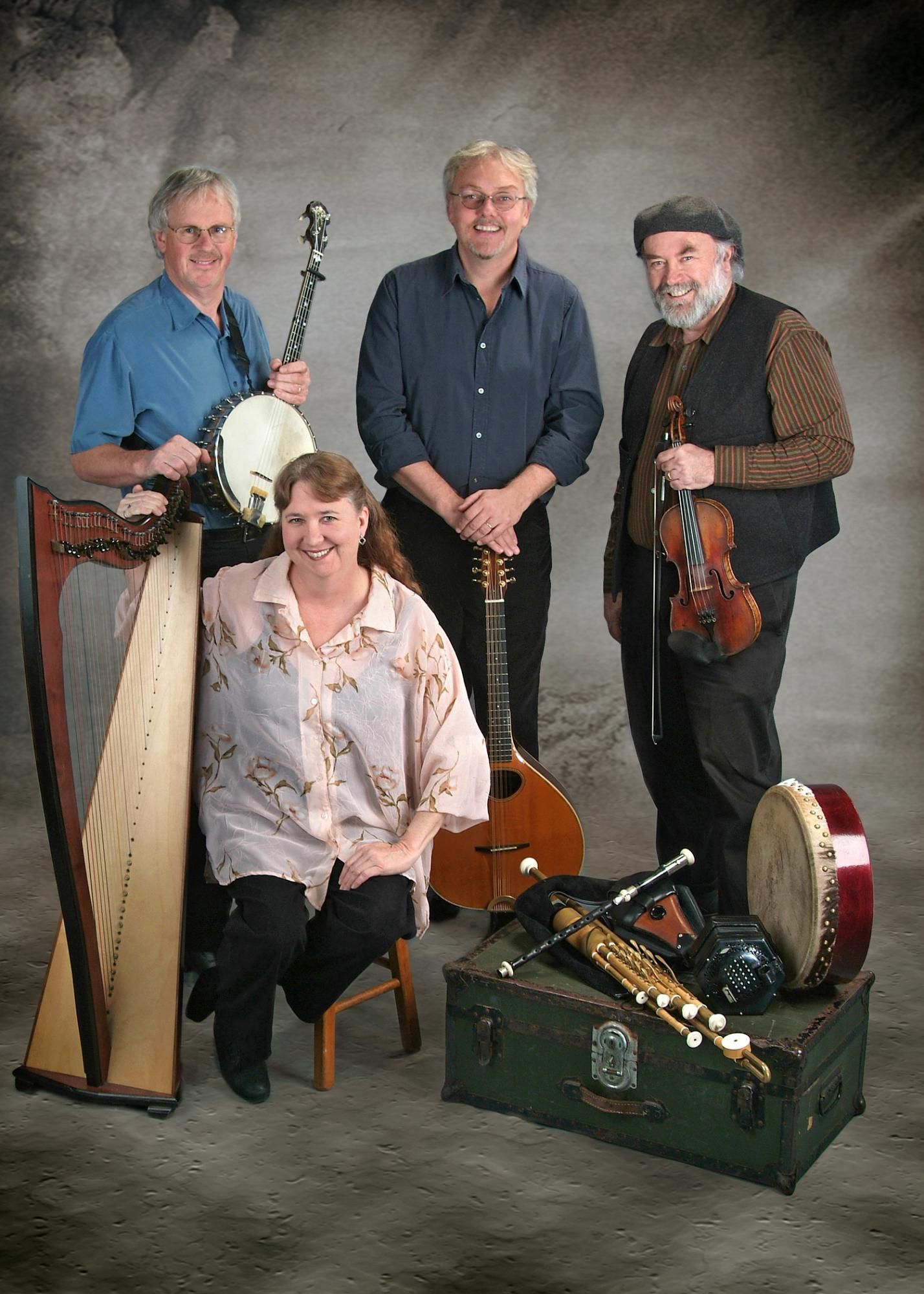 A group of people standing next to each other holding musical instruments.