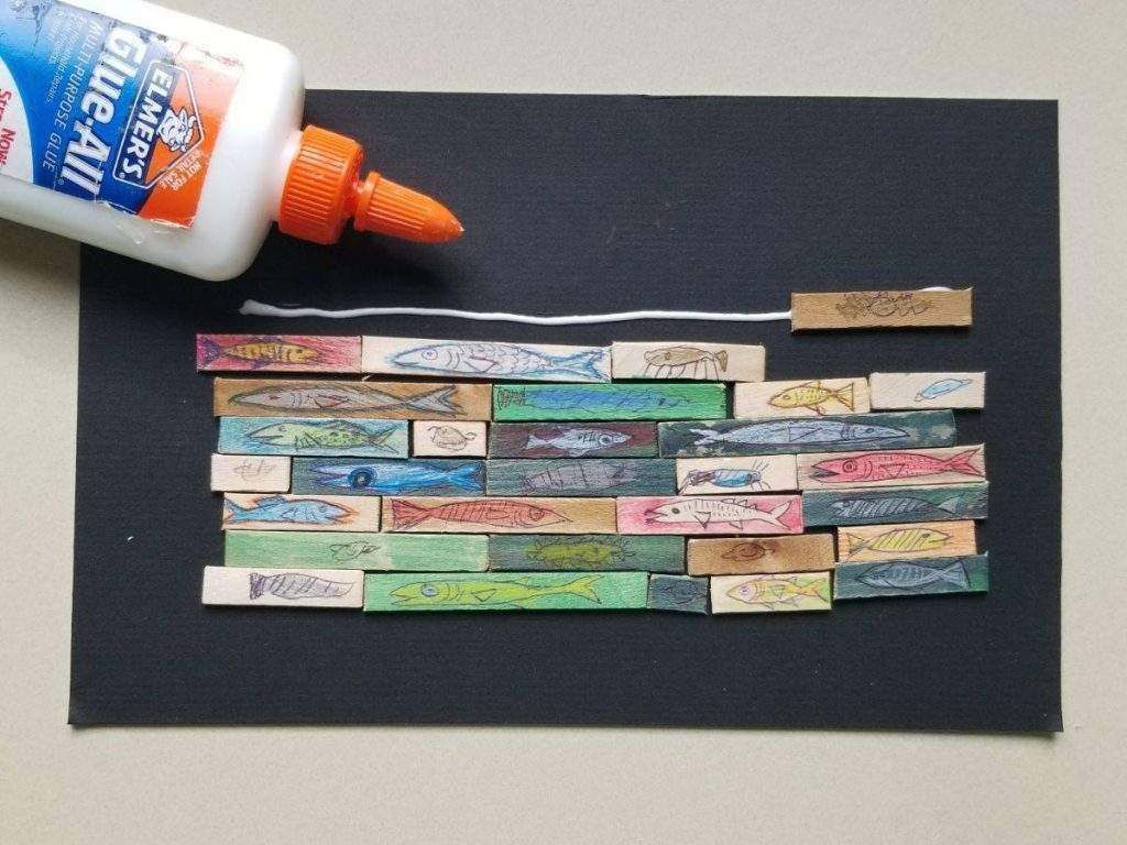 A bottle of glue sits on a piece of paper