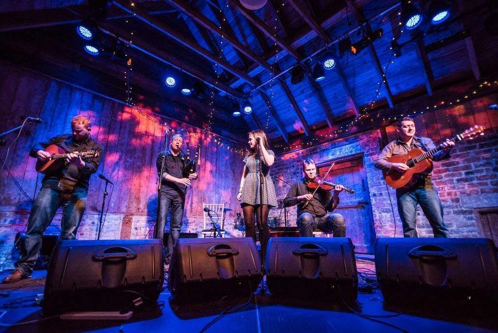 A group of people are playing instruments on a stage.