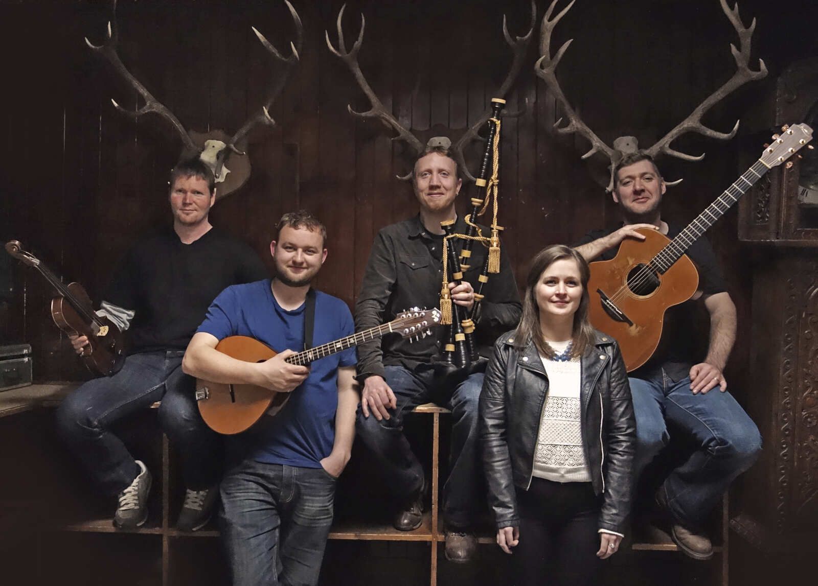 A group of people standing next to each other holding musical instruments.