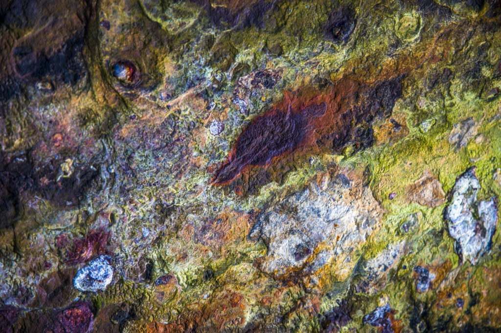 A close up of a rusty metal surface with a painting effect.