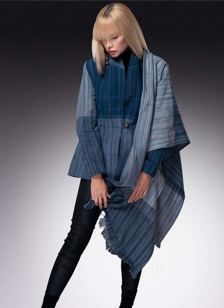 A woman wearing a blue and white striped coat and black pants