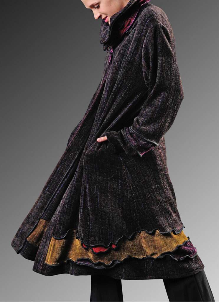 A woman wearing a long black coat with pockets