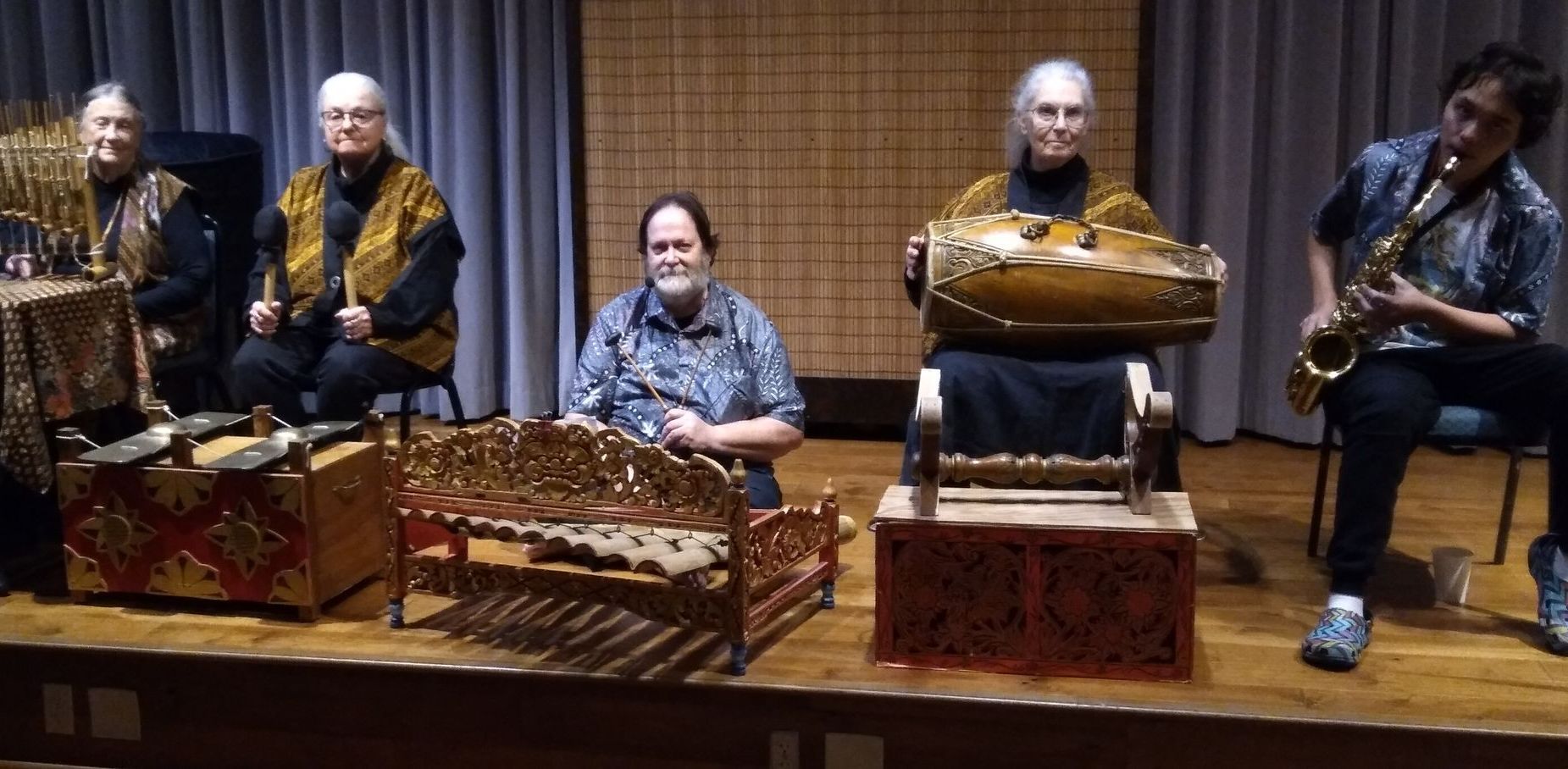 A group of people are playing musical instruments on a stage.