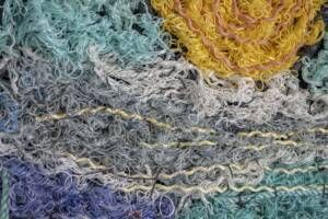 A close up of a pile of colorful yarn.